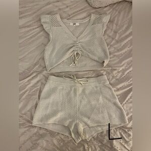 Two bathing suits, and a cover up set.